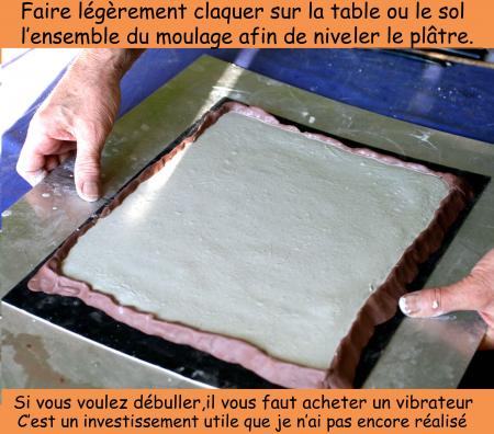 TAPER AVEC DES  PETITES SECOUSSES L'ENSEMBLE DU MOULE SUR LA TABLE OU SUR LE SOL AFIN D'APLATIR ET METTRE A NIVEAU LA COUCHE DE PLATRE. 